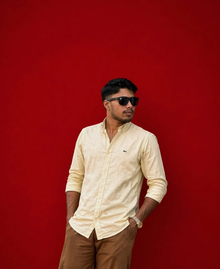Best Freelance Digital Marketing Expert In Dubai | Stylish young man in a beige shirt and sunglasses posing confidently against a bright red wall